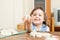 Child sculpting from clay at table