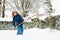 Child shoveling winter snow. Kids clear driveway