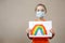 A child shows a drawing of a rainbow during pandemic coronavirus quarantine. Stay at home Social media campaign for coronavirus