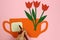 A child signs a Postcard, paper tulips, flowers in a Cup