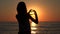 Child Silhouette on Beach, Love Sign in Sunset on Valentine`s Day Heart Shape 4K