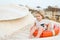 Child sit in ring buoy on sunny day. Little boy with lifebuoy on tropical beach. Kid with blond hair have fun outdoor. Summer vaca