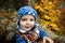 Child sits in autumn park