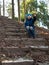 Child sits open-mouthed at the background of trees