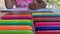 A child sits at a table and enthusiastically draws, paints with colorful felt-tip pens on paper, close-up shooting