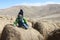 Child sitting on bale of hay