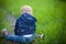 Child sitting on the green grass