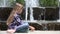 Child Sitting Relaxing in Park by Fountain Watching Water Drops, Girl Outdoor 4K