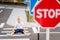 A child is sitting on the road at a pedestrian crossing among road signs, traffic rules for children