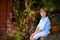 Child sitting under big tree