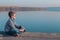 Child sitting at waterfront in beautiful autumn light