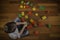 Child sitting on the wooden floor and playing with colorful plastic blocks. Top view