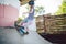 Child skateboarder during learning tricks on a ramp in an urban skate park. boy in a sports helmet rides on a skate board at a