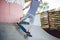 Child skateboarder during learning tricks on a ramp in an urban skate park. boy in a sports helmet rides on a skate board at a