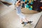 Child skateboarder during learning tricks on a ramp in an urban skate park. boy in a sports helmet rides on a skate board at a