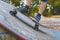 A child skates on a longboard at a ramp