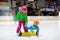 Child skating on indoor ice rink. Kids skate