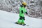 Child skiing in mountains. Active toddler kid with safety helmet, goggles and poles. Ski race for young children. Winter
