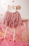 Child skirt on hanger on pink background