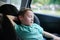 Child sleeping in a car. Baby savety chair. Transportation background. Travelling with family.