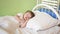 Child sleeps in the hospital ward. concept of sleeping child. charming baby falls asleep on white bed in his bed .