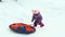Child slides on snow tubing