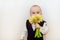 Child is sniffing yellow daffodils