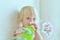 The child sniffs decorative flowers. Portrait of a little girl with flowers