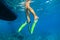 Child in snorkelling fins stand on divers boat ladder