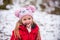 Child in snow. Little Girl having fun in the winter snowy park.