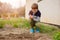 Child sowing vegetables in the home garden.