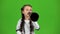 Child speaks into the loudspeaker. Green screen. Slow motion