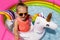 A child splashes in clear clear water on a hot summer day