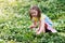 Child in spring park with flowers