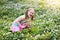 Child in spring park with flowers