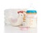 Child stack of diapers, nipple, toe and baby feeding bottle with