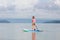 Child on stand up paddle. Water and beach sport