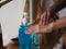 Child is standing with the finger to rub the gel alcoholic 70 percent mixture with gelatin on the back of the hand to prevent