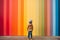 A child standing on front of rainbow colored wall. Child mental health concept. ASD, autism spectrum disorder awareness concept.