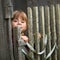 Child standing near vintage rural fence