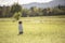 Child standing in waves of grain in field