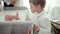 Child stands next to the changing table