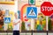 A child stands at a Pedestrian crossing sign and points at it with his finger, traffic rules for children