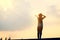 The child stands pointing forward glad the sky background