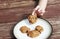 Child stealing a pumpkin chocolate chip cookie from a plate.