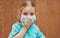 Child in a sterile protective medical mask. Sick little girl. Epidemic of flu.