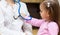 Child with stethoscope examining a doctor