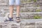 Child stood on the steps dilapidated and an overgrown with grass