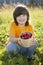 Child with strawberries sunny garden with a summer day