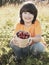 Child with strawberries sunny garden with a summer day